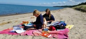 High School Oak Meadow students studying on beach